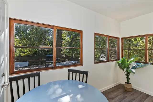 a view of a porch with furniture and wooden floor