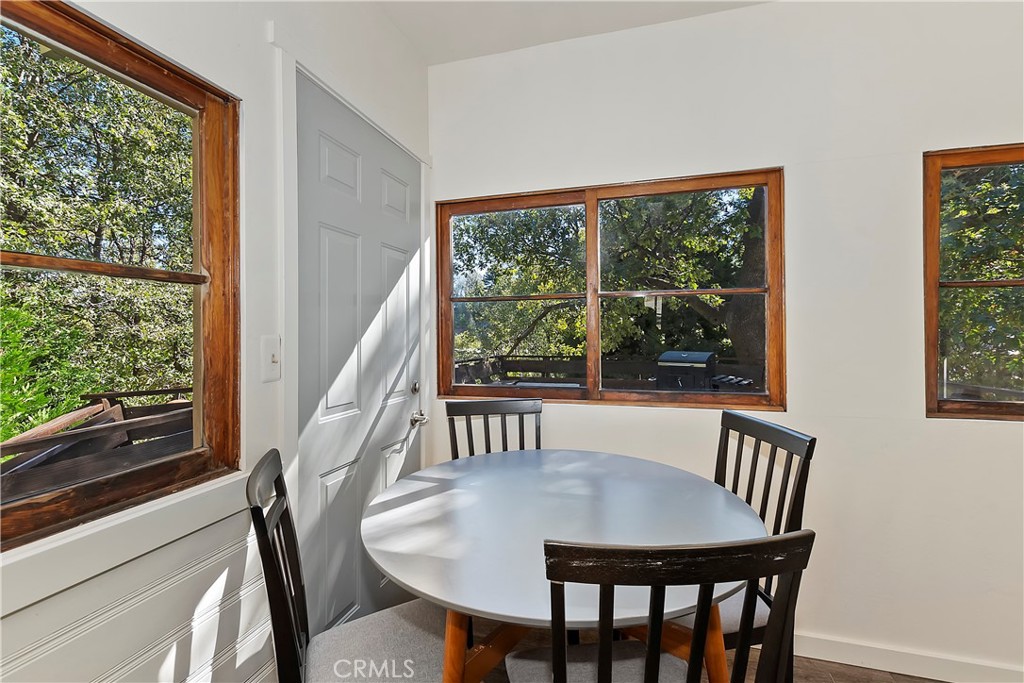 1262 Bear Springs Road Rimforest, CA 92378 - Photo 17 of 34 a view of a dining room with furniture window and wooden floor