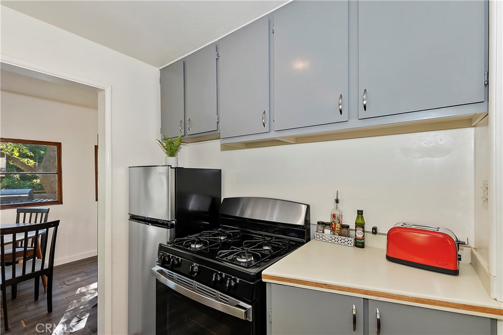 1262 Bear Springs Road Rimforest, CA 92378 - Photo 20 of 34 a kitchen with cabinets and appliances