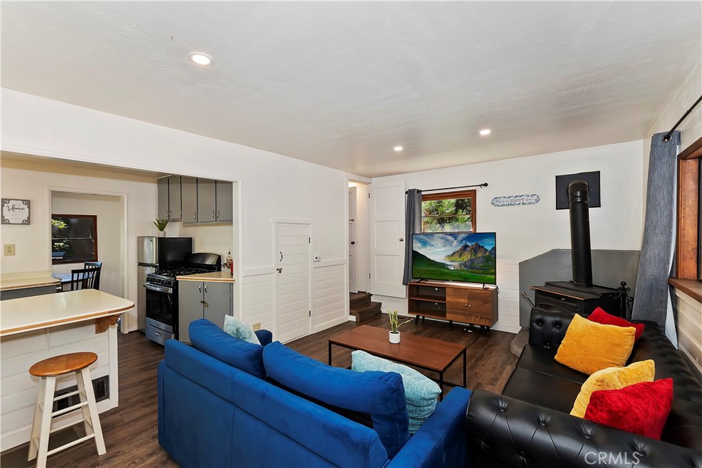 1262 Bear Springs Road Rimforest, CA 92378 - Photo 10 of 34 a living room with furniture and a flat screen tv