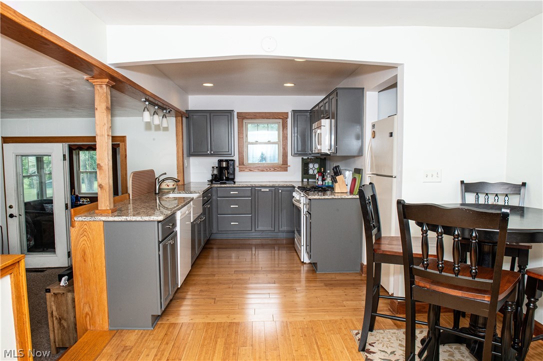 1755 Salt Springs Road Warren, OH 44481 - Photo 14 of 40 Kitchen with plenty of natural light, bamboo hardwood floors, w appliances remain, and gray cabinetry with granite counter tops