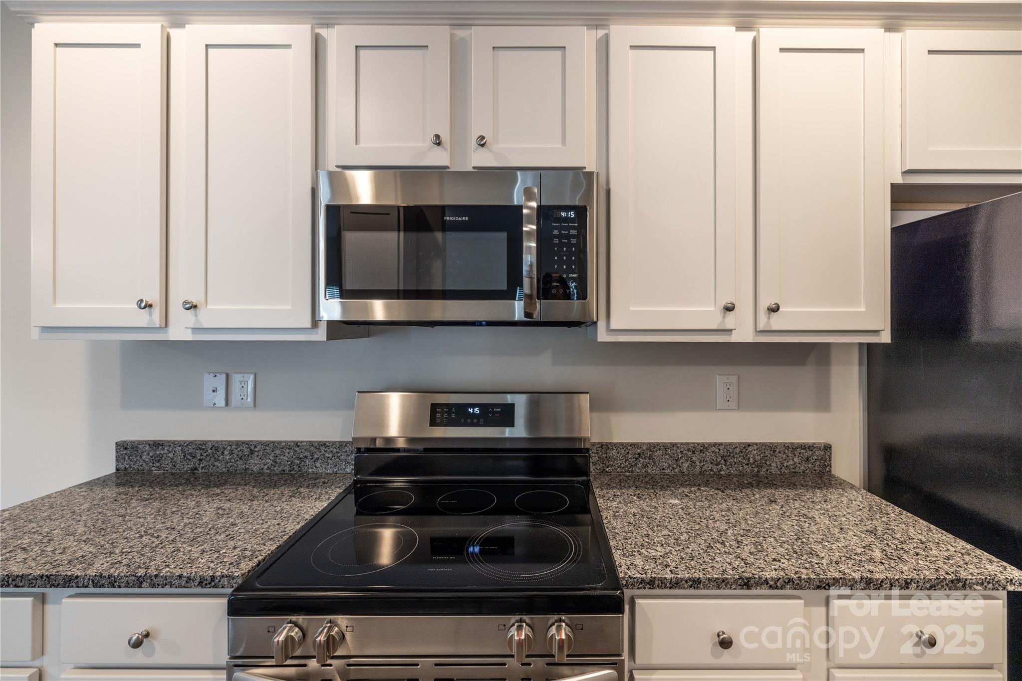 146 South Bell Avenue Albemarle, NC 28001 - Photo 13 of 36 a kitchen with granite countertop white cabinets and stainless steel appliances