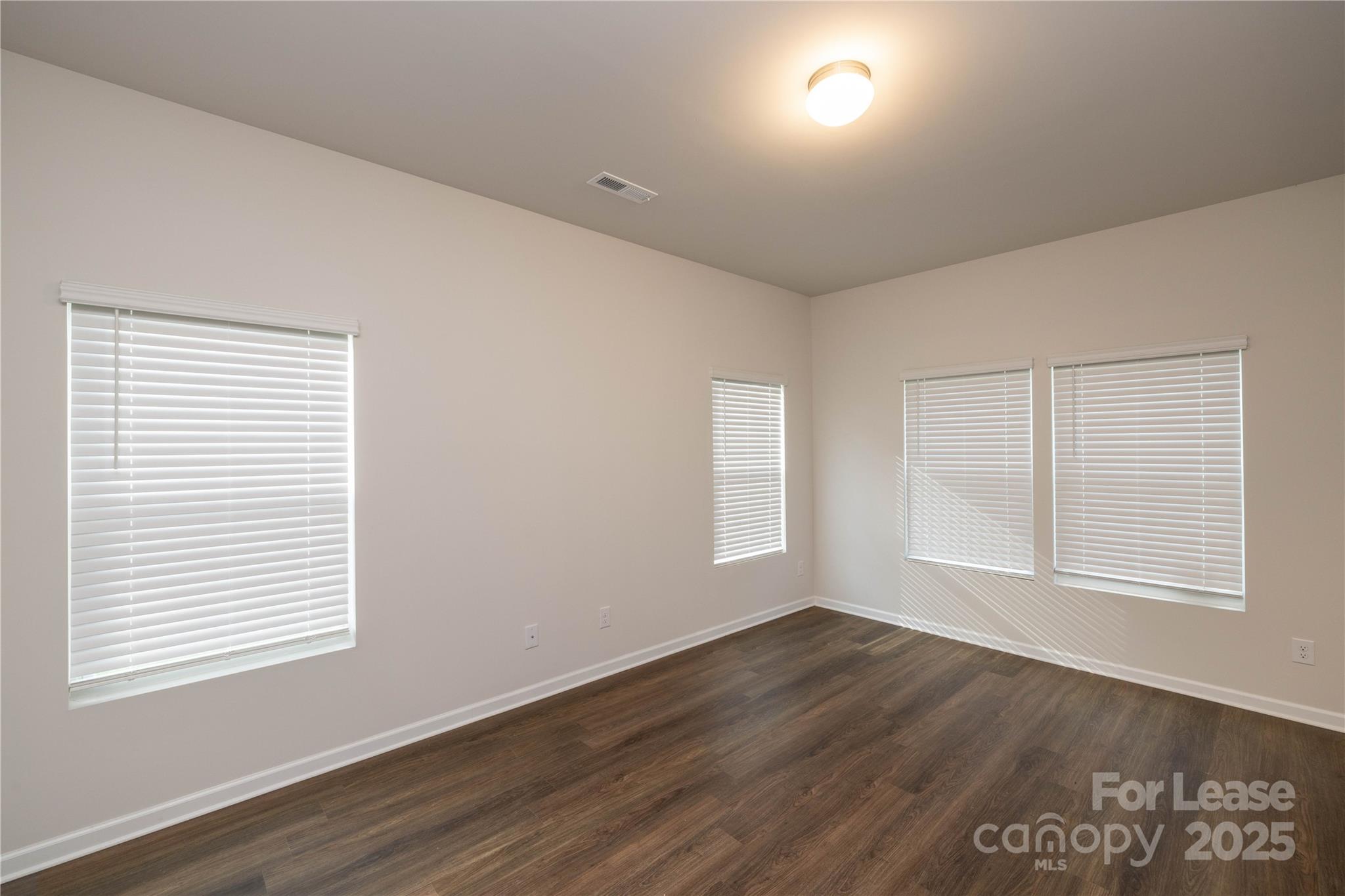 146 South Bell Avenue Albemarle, NC 28001 - Photo 5 of 36 a view of an empty room with wooden floor and a window