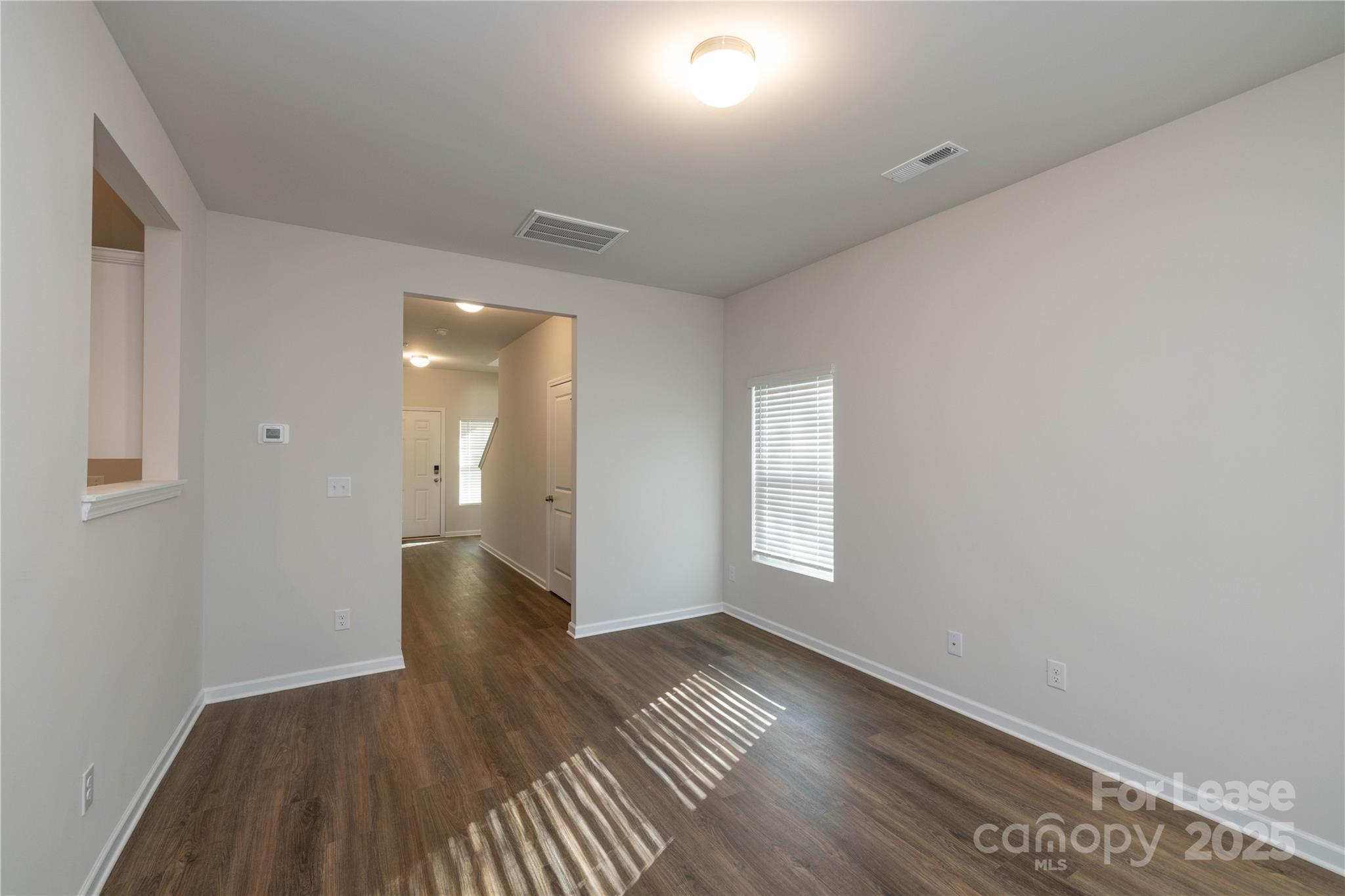 146 South Bell Avenue Albemarle, NC 28001 - Photo 8 of 36 wooden floor in an empty room with a window