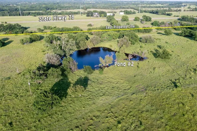 a front view of house with yard and trees in the background