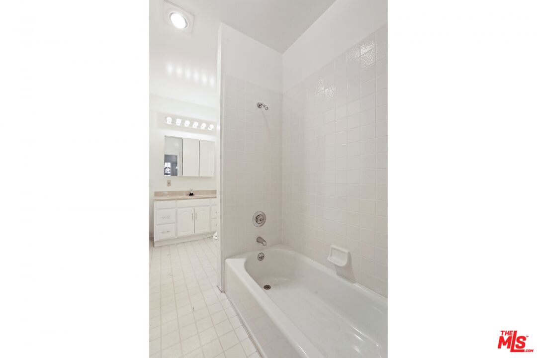 1126 Mohawk Street Los Angeles, CA 90026 - Photo 12 of 47 a bathroom with a tub shower sink and a toilet