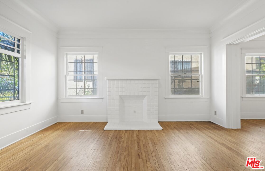 1126 Mohawk Street Los Angeles, CA 90026 - Photo 18 of 47 an empty room with wooden floor and windows