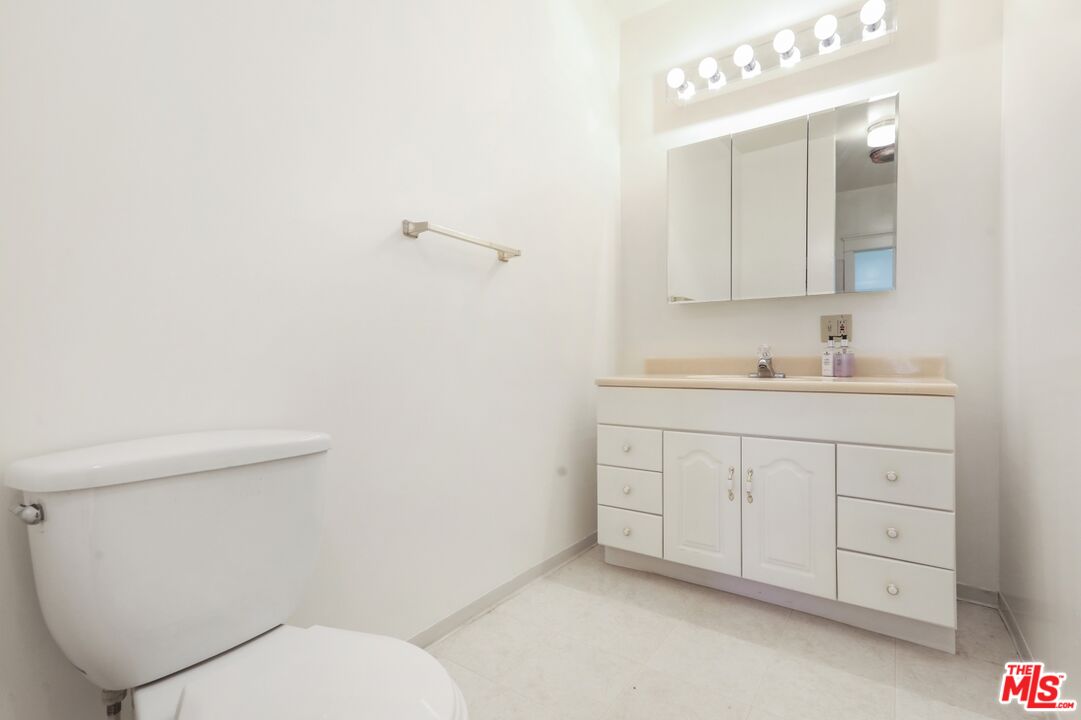 1126 Mohawk Street Los Angeles, CA 90026 - Photo 26 of 47 a bathroom with a toilet sink and mirror
