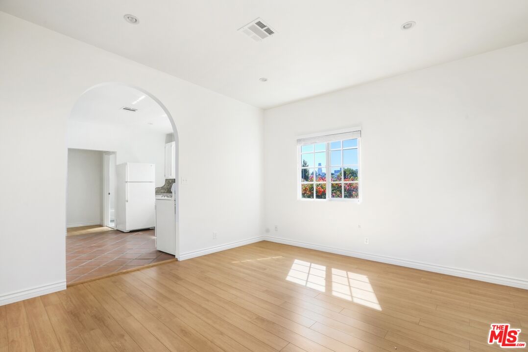 1126 Mohawk Street Los Angeles, CA 90026 - Photo 37 of 47 a view of an empty room with wooden floor and a window