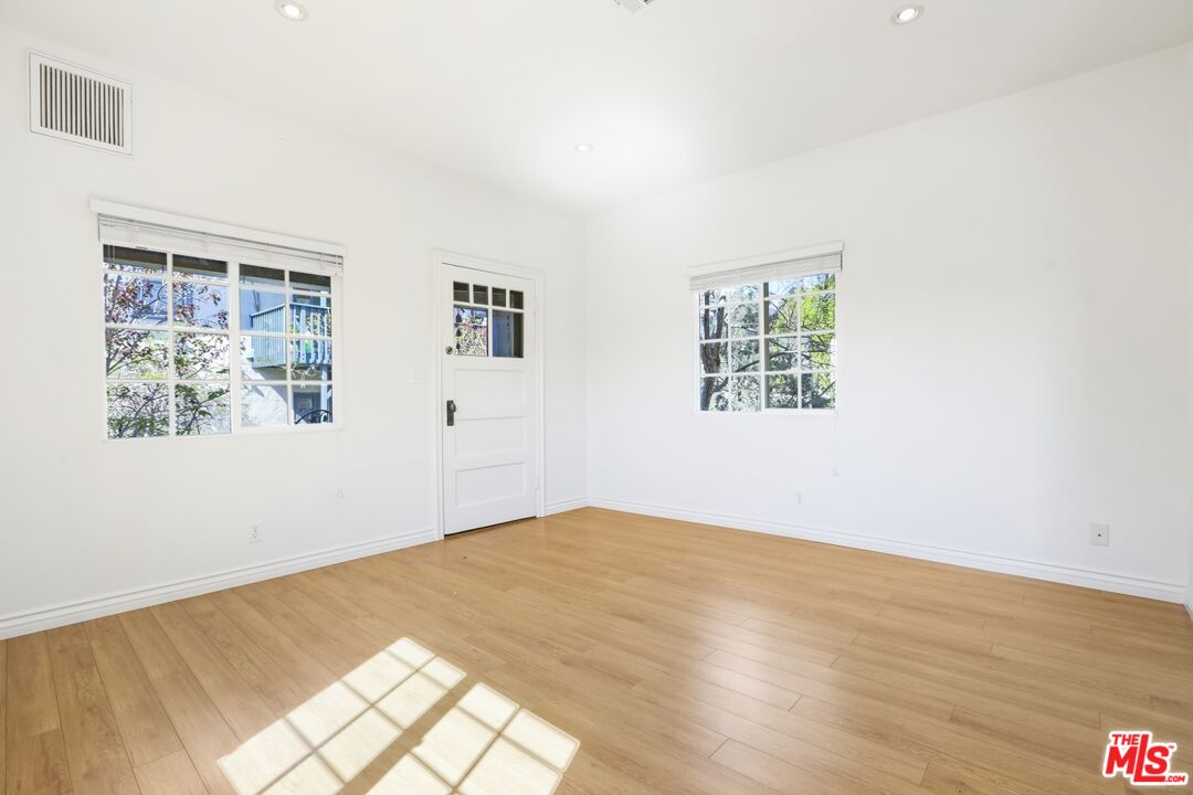1126 Mohawk Street Los Angeles, CA 90026 - Photo 38 of 47 a view of an empty room with wooden floor and a window