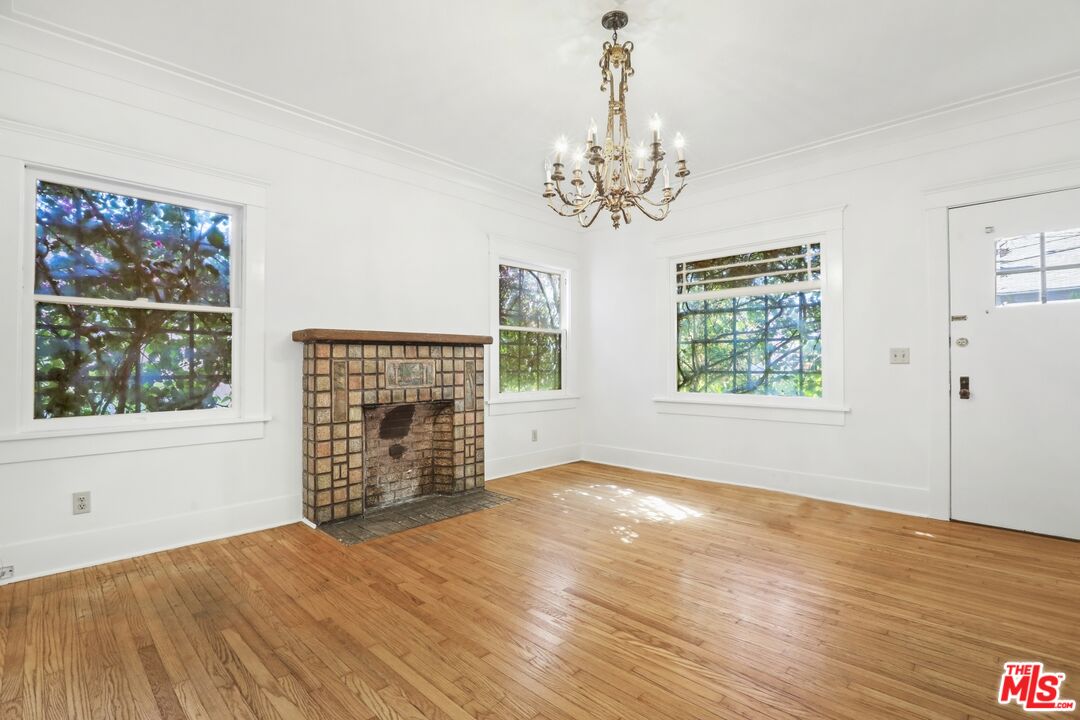 1126 Mohawk Street Los Angeles, CA 90026 - Photo 4 of 47 a view of an empty room with wooden floor and a window