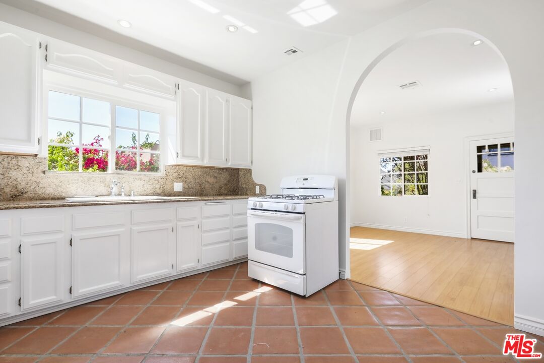 1126 Mohawk Street Los Angeles, CA 90026 - Photo 41 of 47 a kitchen with a sink cabinets and window