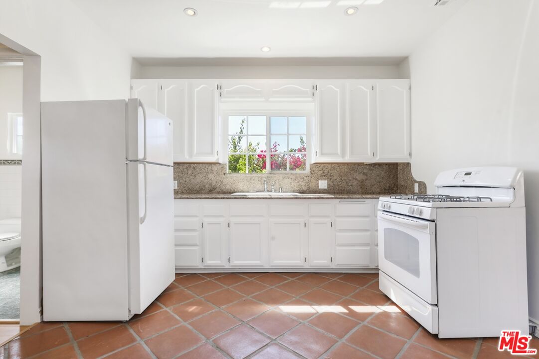 1126 Mohawk Street Los Angeles, CA 90026 - Photo 42 of 47 a kitchen with white cabinets and white appliances