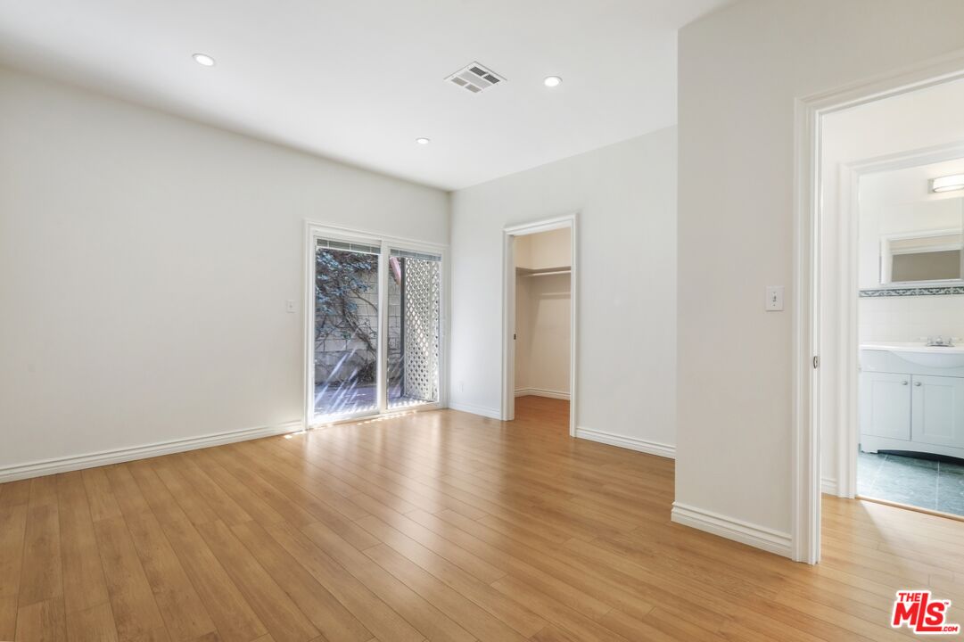 1126 Mohawk Street Los Angeles, CA 90026 - Photo 43 of 47 a view of an empty room with wooden floor and a window