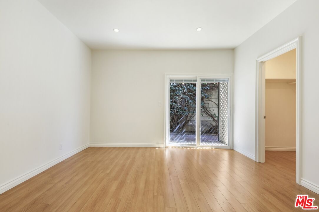 1126 Mohawk Street Los Angeles, CA 90026 - Photo 44 of 47 an empty room with wooden floor and a window