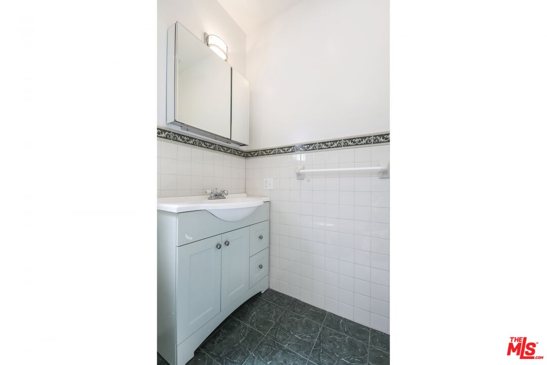 1126 Mohawk Street Los Angeles, CA 90026 - Photo 46 of 47 a bathroom with a sink and a mirror