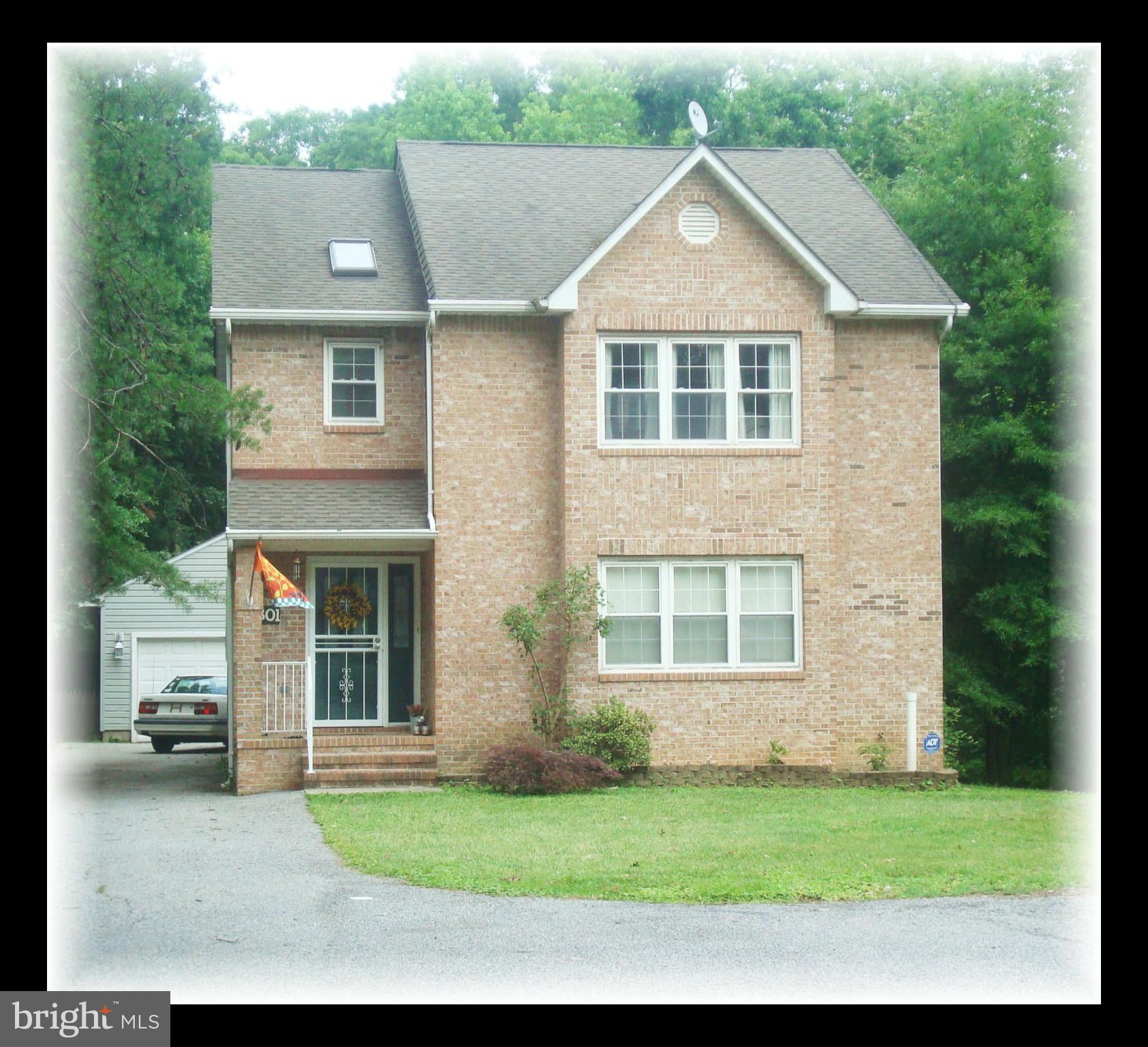 301 Bowleys Quarters Road Baltimore, MD 21220 - Photo 1 of 30 a view of a yard in front of a house with a large tree
