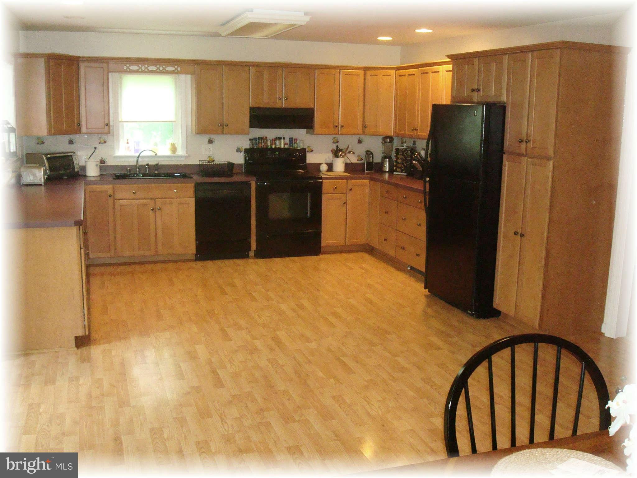 301 Bowleys Quarters Road Baltimore, MD 21220 - Photo 13 of 30 a kitchen with stainless steel appliances granite countertop a refrigerator a stove a sink and a microwave