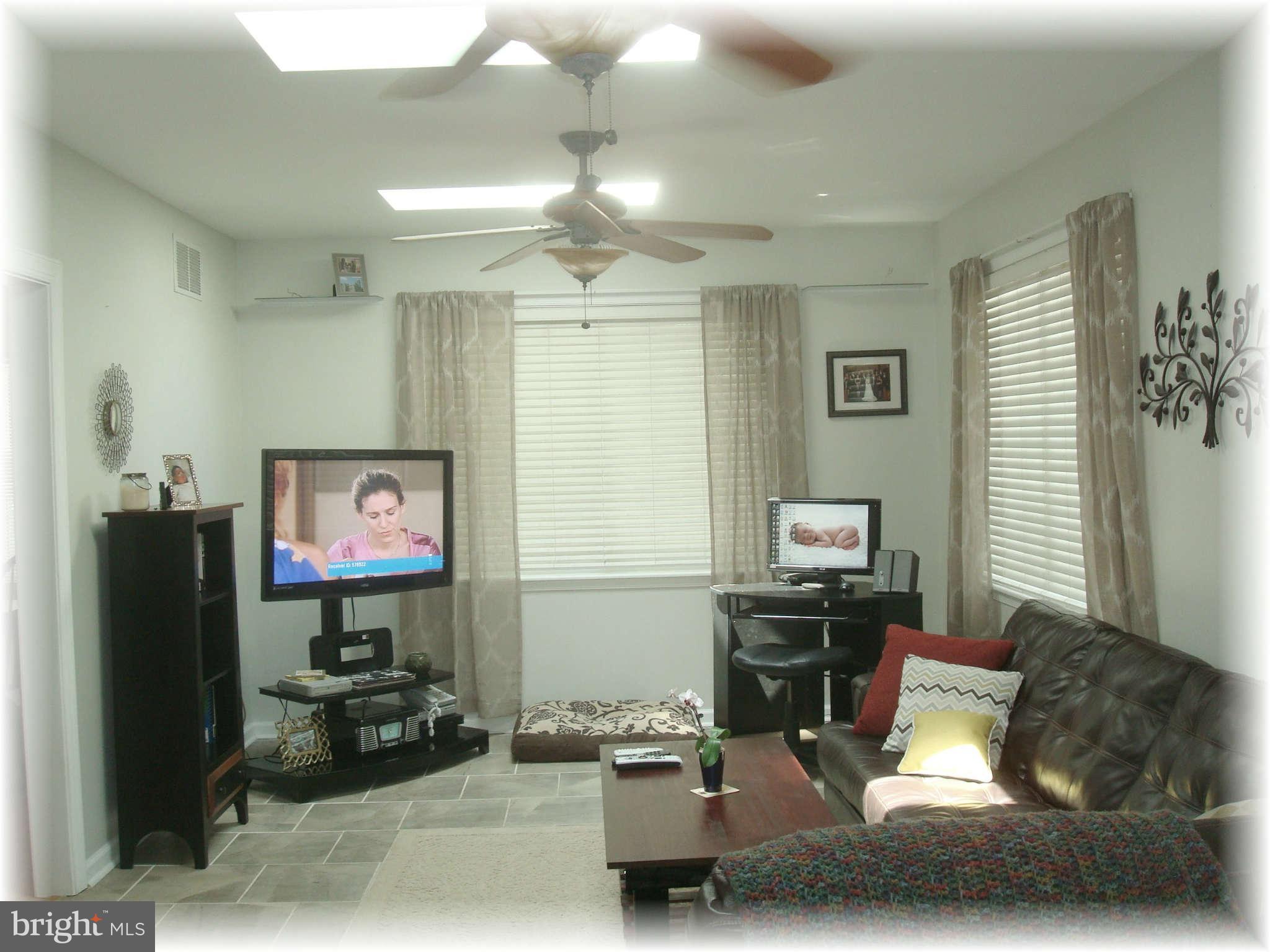 301 Bowleys Quarters Road Baltimore, MD 21220 - Photo 17 of 30 a living room with furniture and a flat screen tv