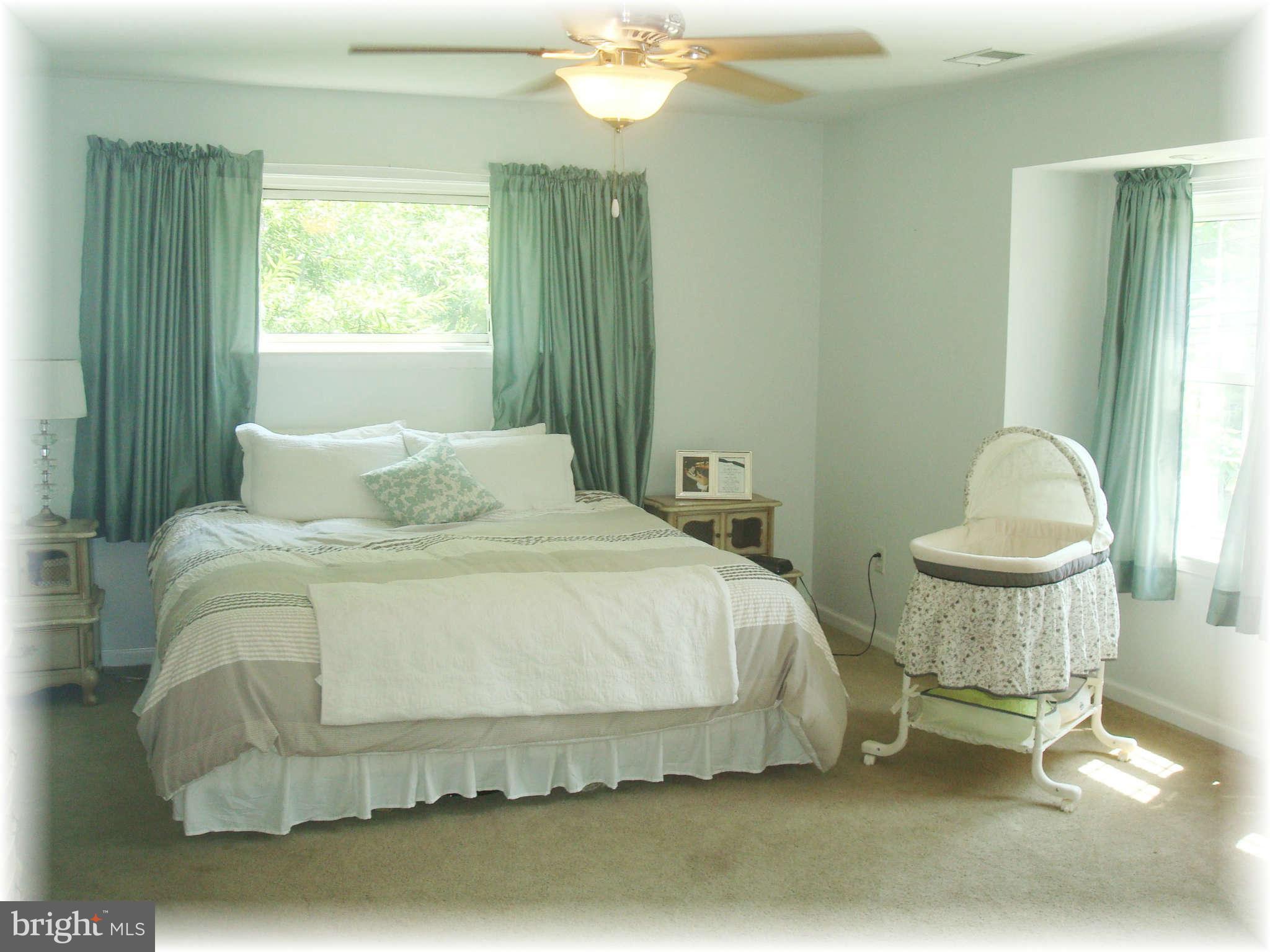 301 Bowleys Quarters Road Baltimore, MD 21220 - Photo 20 of 30 a bedroom with a bed a table and chair