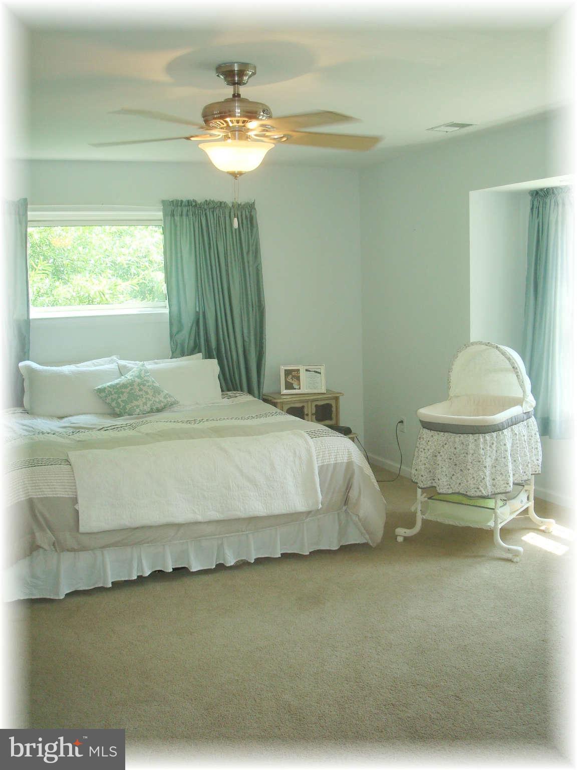 301 Bowleys Quarters Road Baltimore, MD 21220 - Photo 21 of 30 a bedroom with a bed and a chandelier