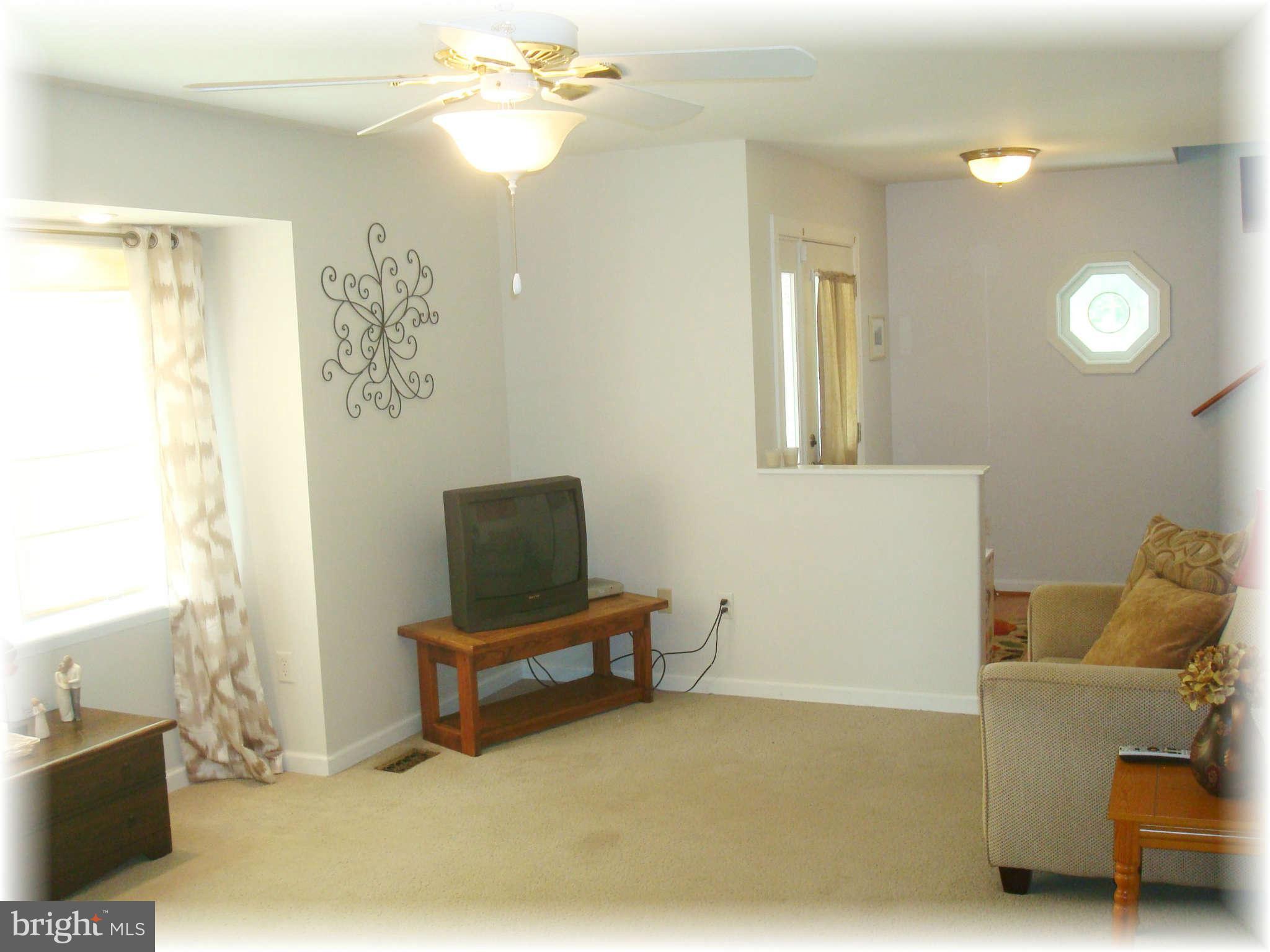 301 Bowleys Quarters Road Baltimore, MD 21220 - Photo 9 of 30 a living room with furniture and a flat screen tv