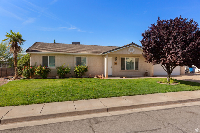 664 East Springhill Drive Washington, UT 84780 - Photo 2 of 21 Single-story residence featuring a low-pitched roof, stucco exterior, and an attached two-car garage