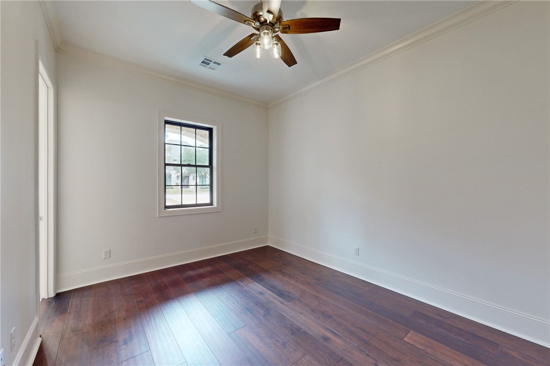 3317 Legacy Court Bryan, TX 77802 - Photo 20 of 28 an empty room with wooden floor ceiling fan and windows