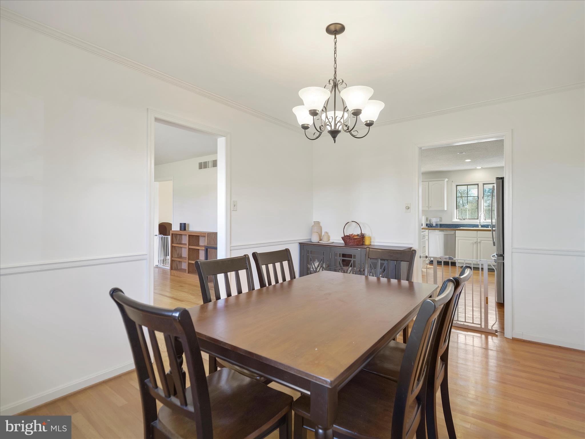 6527 Morningside Court Middletown, MD 21769 - Photo 18 of 42 a view of a dining room with furniture a chandelier and wooden floor