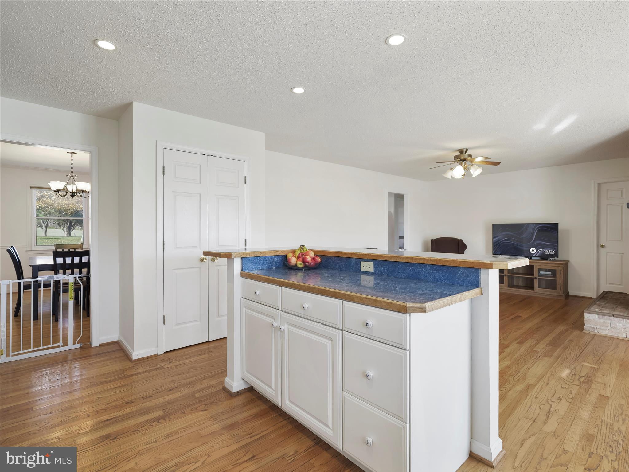 6527 Morningside Court Middletown, MD 21769 - Photo 20 of 42 a kitchen with granite countertop a stove and white cabinets with wooden floor