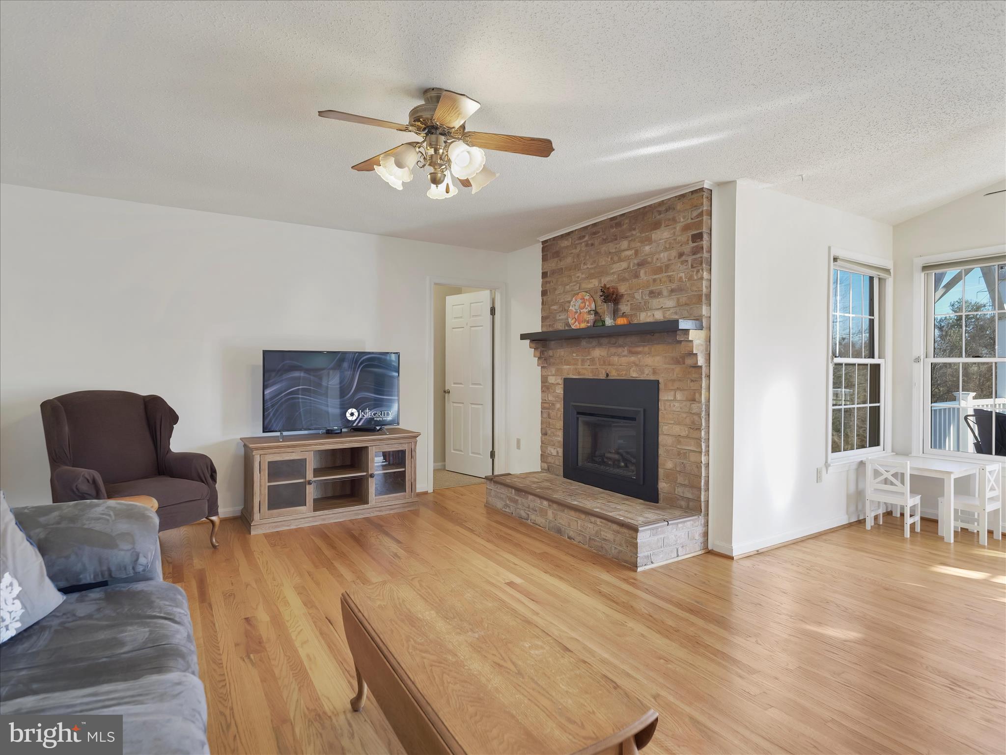 6527 Morningside Court Middletown, MD 21769 - Photo 25 of 42 a living room with furniture and a fireplace