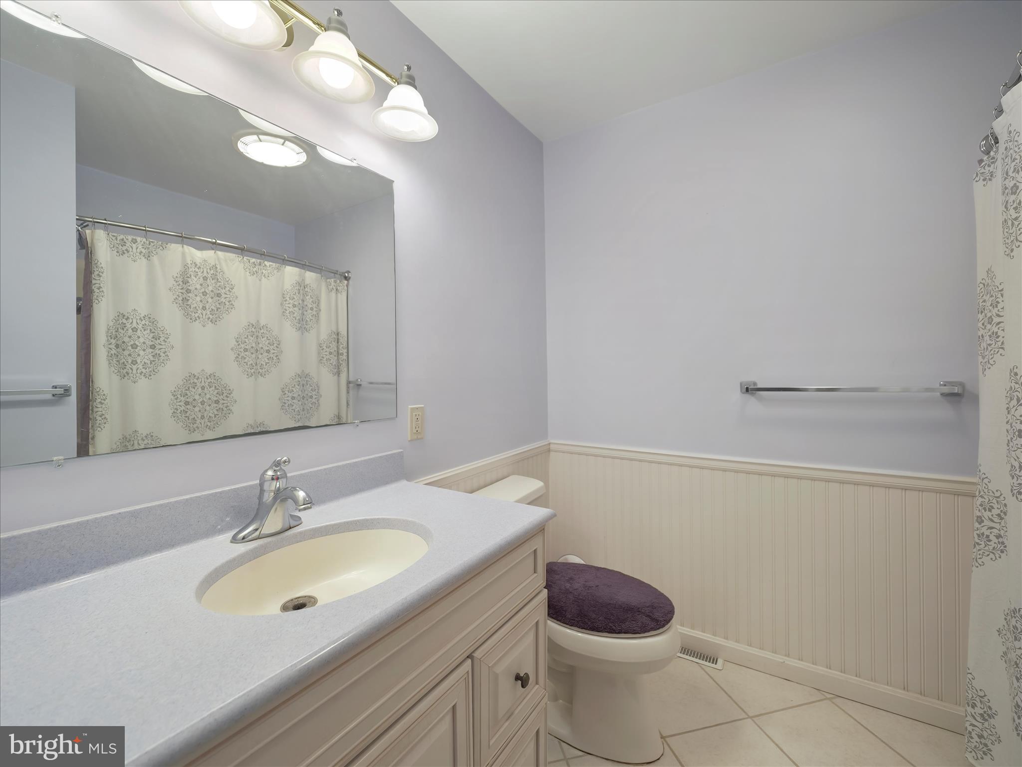 6527 Morningside Court Middletown, MD 21769 - Photo 37 of 42 a bathroom with a granite countertop sink a toilet and a mirror