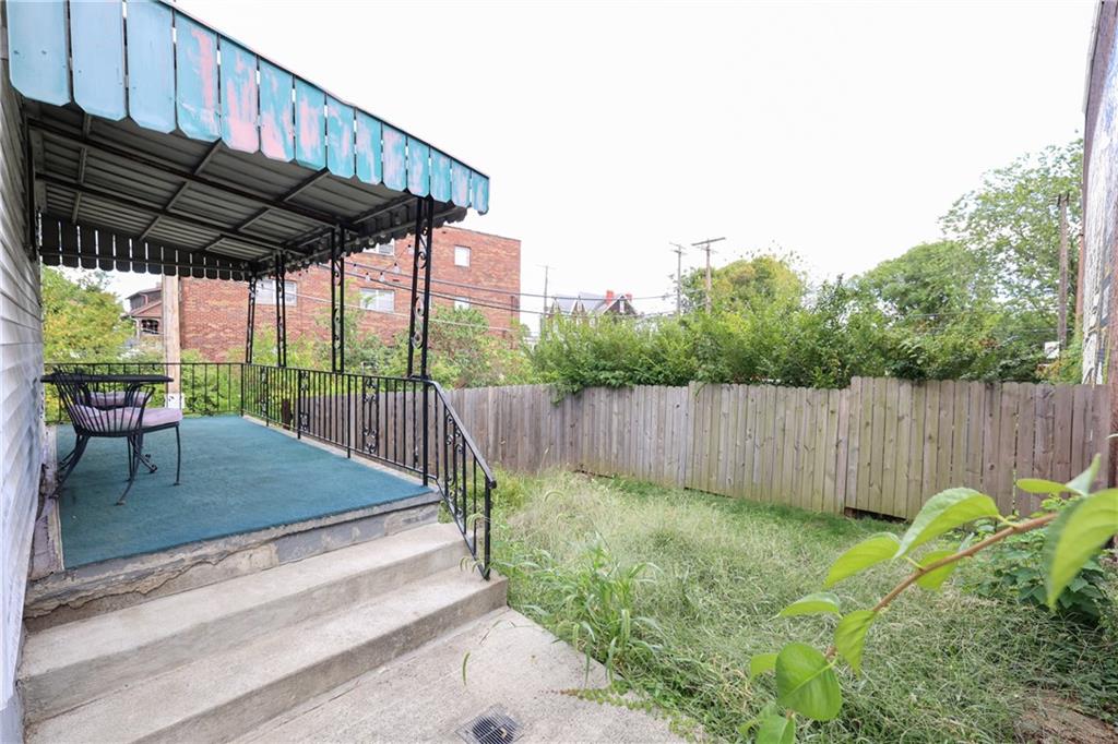 1845 Ley Street Pittsburgh, PA 15212 - Photo 34 of 41 a view of a backyard with table and chairs under an umbrella with a small yard