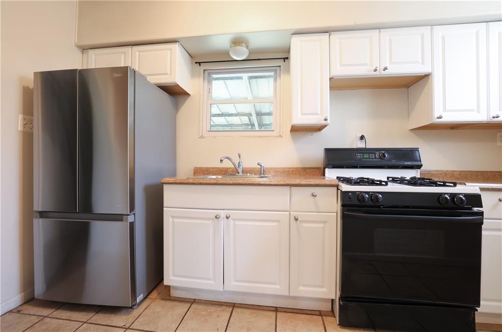 1845 Ley Street Pittsburgh, PA 15212 - Photo 9 of 41 a kitchen with a refrigerator sink and cabinets