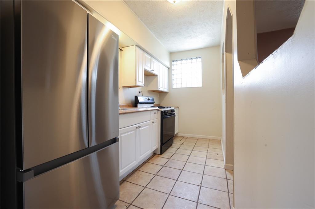 1845 Ley Street Pittsburgh, PA 15212 - Photo 10 of 41 a kitchen with a sink a counter top space and cabinets