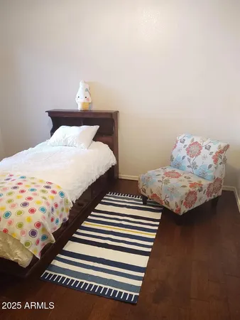 a bedroom with two beds and a lamp on table