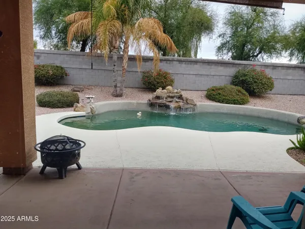 a view of a backyard with plants and outdoor seating