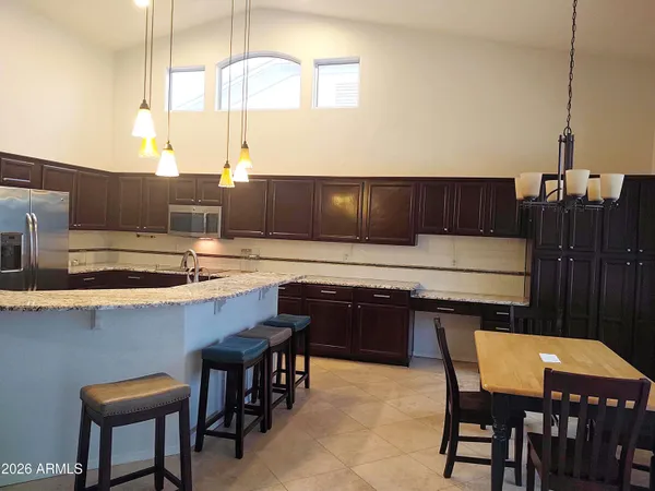 a kitchen with a table chairs sink and cabinets