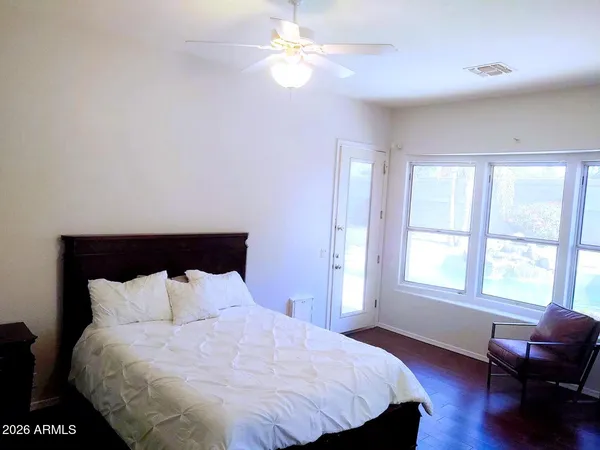 a large bed sitting in a bedroom next to a window