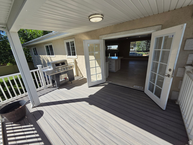 6123 Rodeo Lane Murray, UT 84121 - Photo 14 of 20 Covered outdoor deck with composite decking, white railing, and a beadboard ceiling