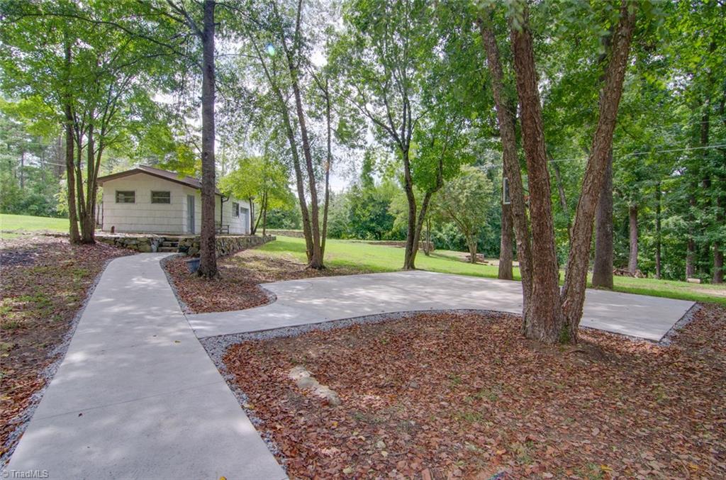 205 Shadow Valley Road High Point, NC 27262 - Photo 26 of 30 Seller had sidewalks poured leading to a custom basketball court and also leads to the sauna and detached garage area, Ample storage!