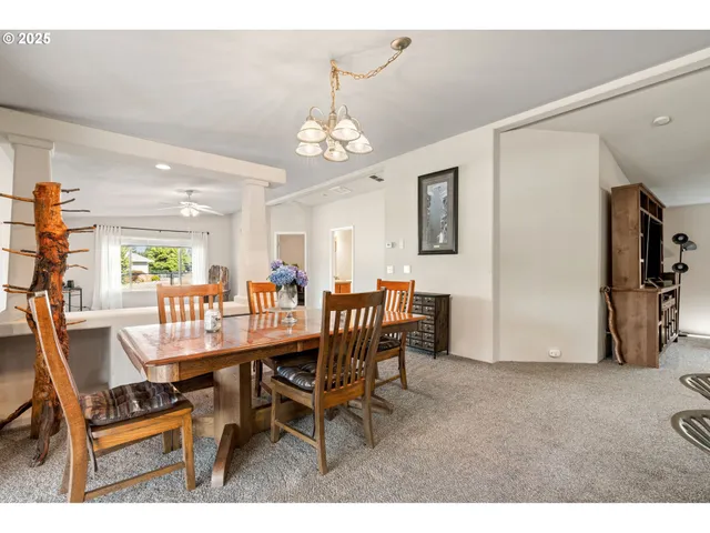 a view of a dining room with furniture and chandelier
