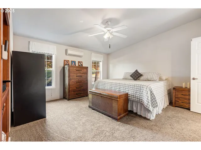 a bedroom with a bed closet and a flat tv screen