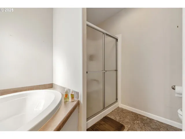 a bathroom with a bathtub and a shower