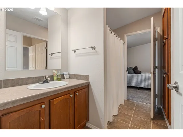 a en suite bathroom with a sink a mirror and a shower