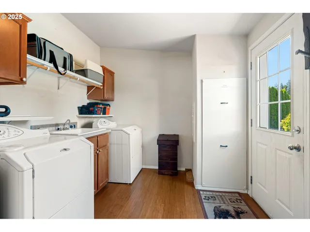 a kitchen with cabinets and wooden floor