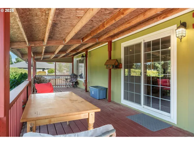 a view of a backyard with a table and chairs