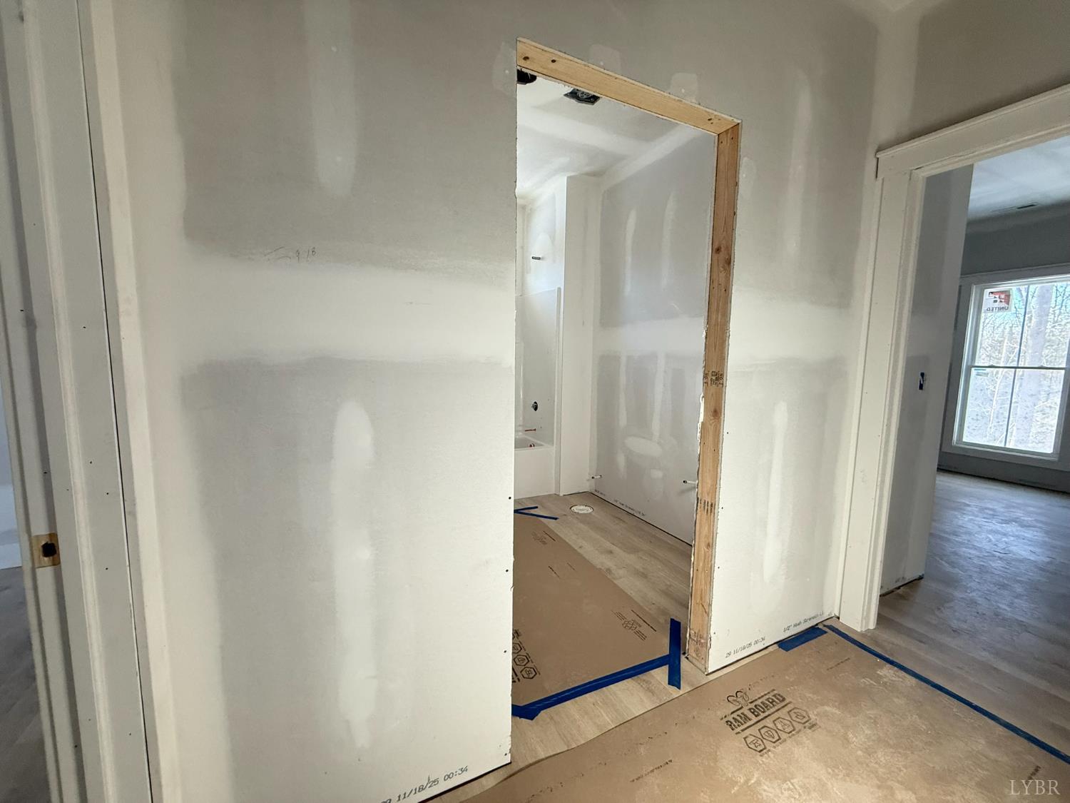 116 Blue Sky Court Monroe, VA 24574 - Photo 32 of 44 an empty room with wooden floor and a bathroom