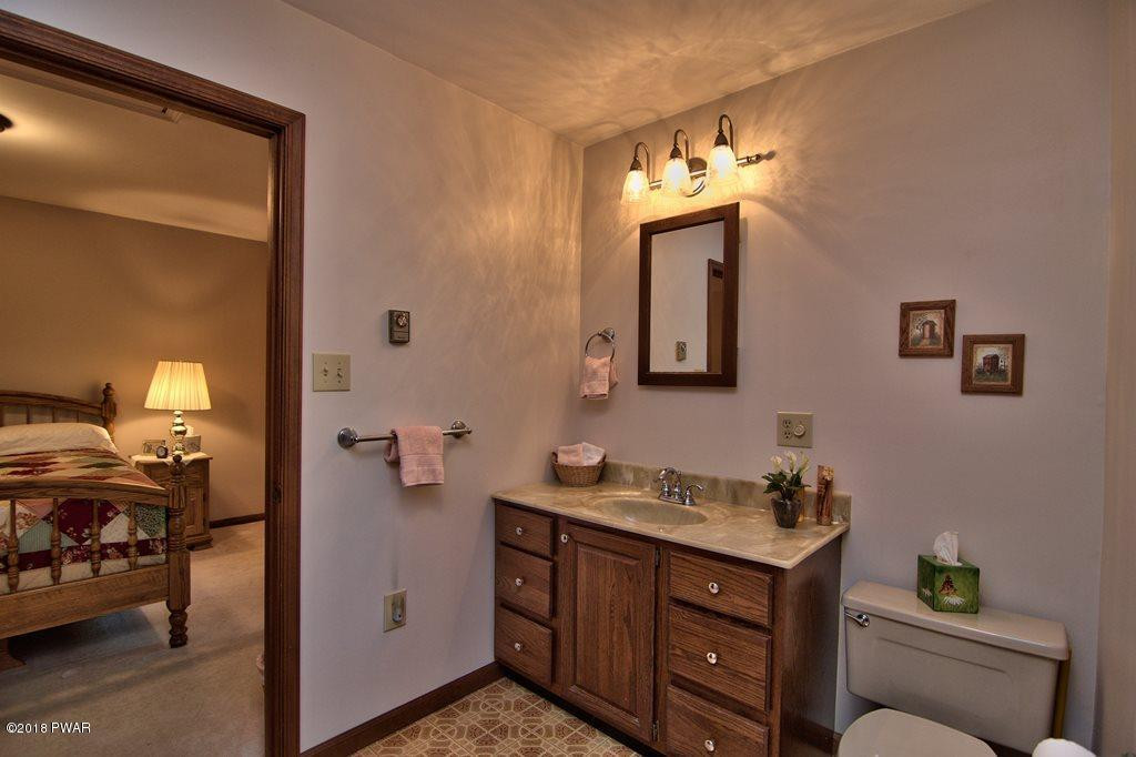 1 East Lake Road Moscow, PA 18444 - Photo 29 of 88 a bathroom with a toilet a sink and a mirror