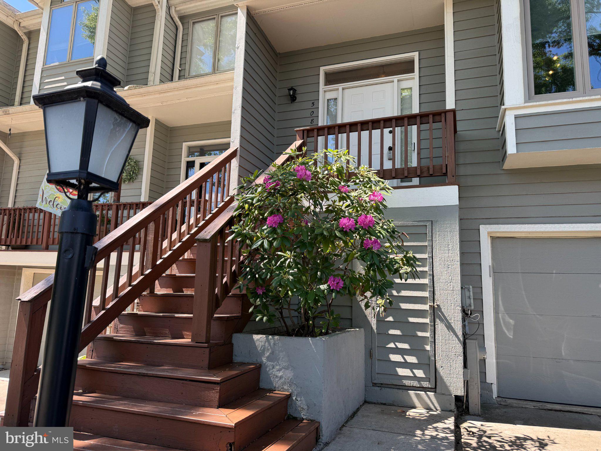 5081 Columbia Road, Unit 17 105 Columbia, MD 21044 - Photo 2 of 40 Charming entrance with vibrant blooms.